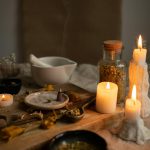 Spiritual Consultant UK - Trusted Traditional Healing Services - Herbs on wooden board next to burning candles