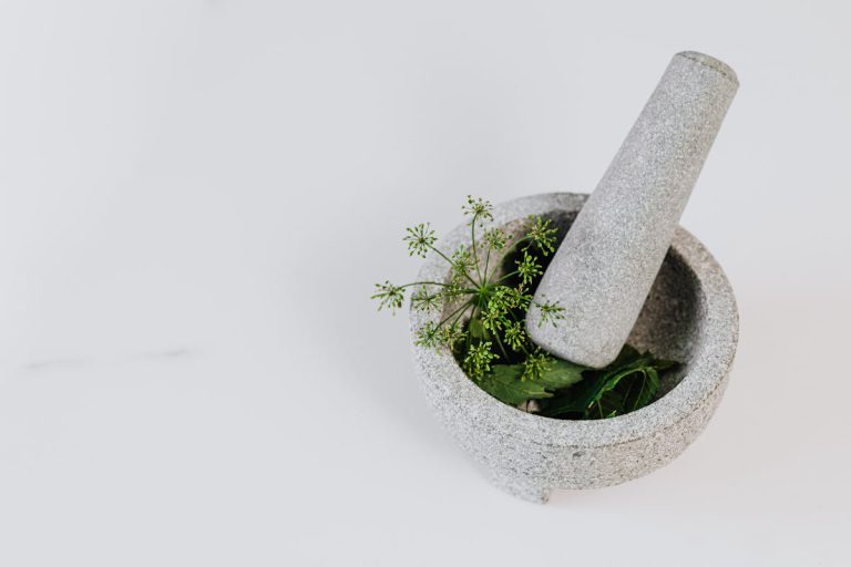 African Spiritual Healer UK - Cleansing, Protection, and Relationship Clarity - Mortar and pestle with green leaves and edible flowers